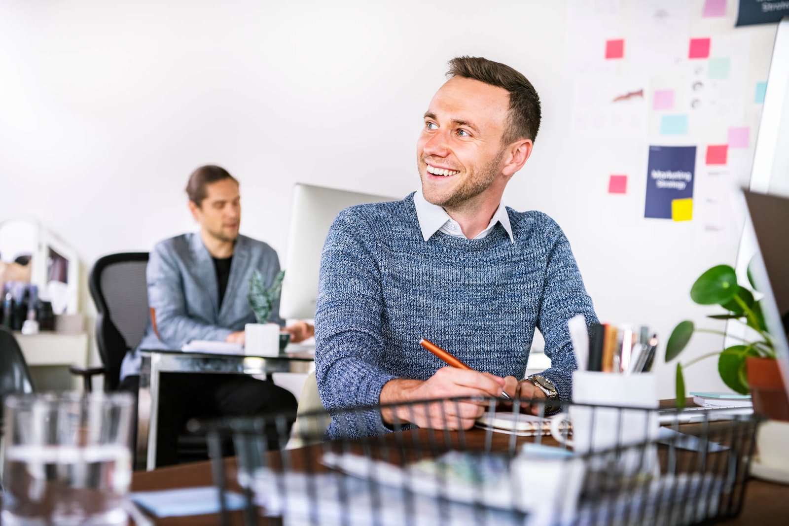 happy-businessman-taking-notes-in-the-office-2021-09-02-06-03-46-utc.jpg